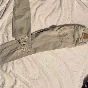 Light gray, ripped skinny jeans.